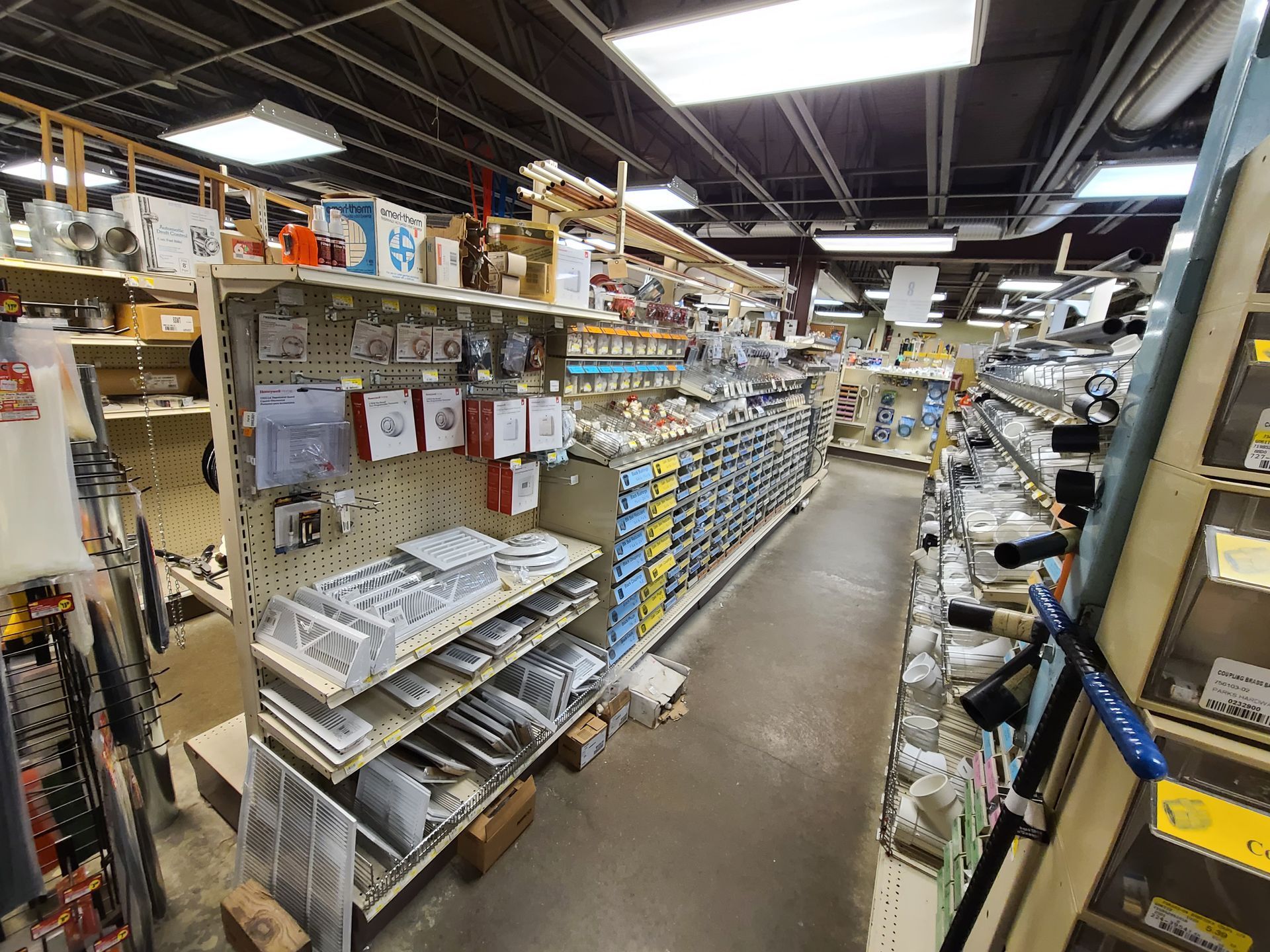 The inside of a hardware store filled with lots of shelves.