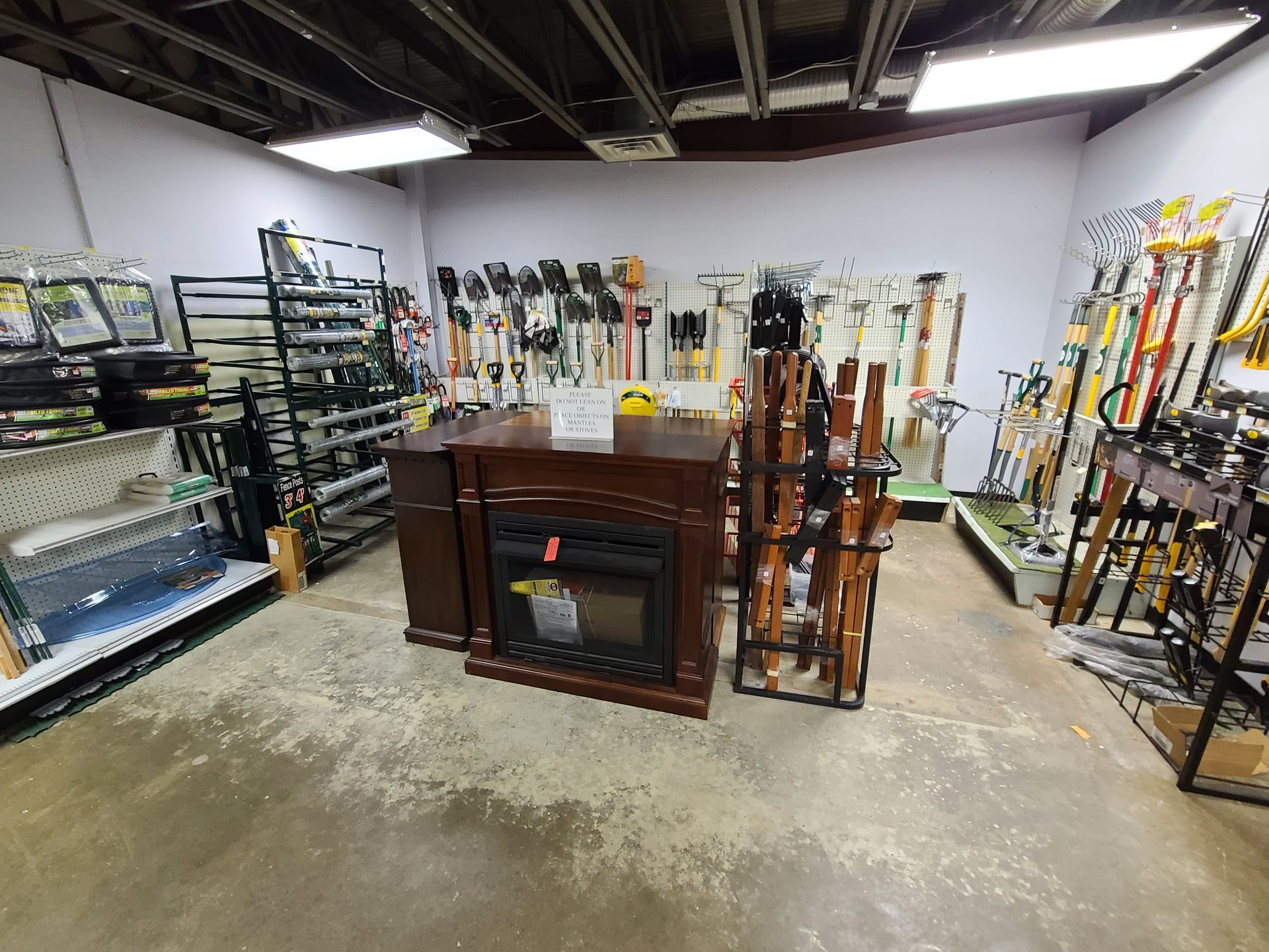 A store filled with lots of tools and a fireplace.