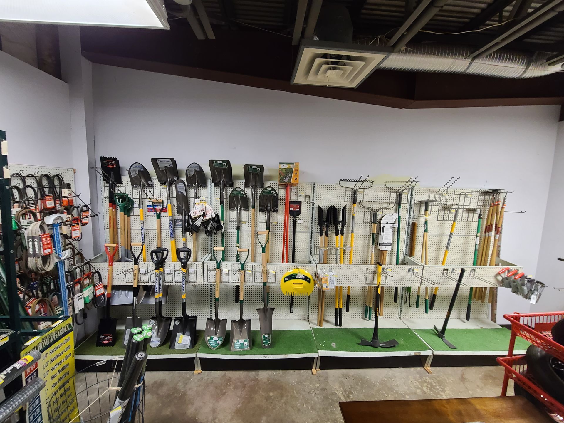 A bunch of tools are hanging on a wall in a room