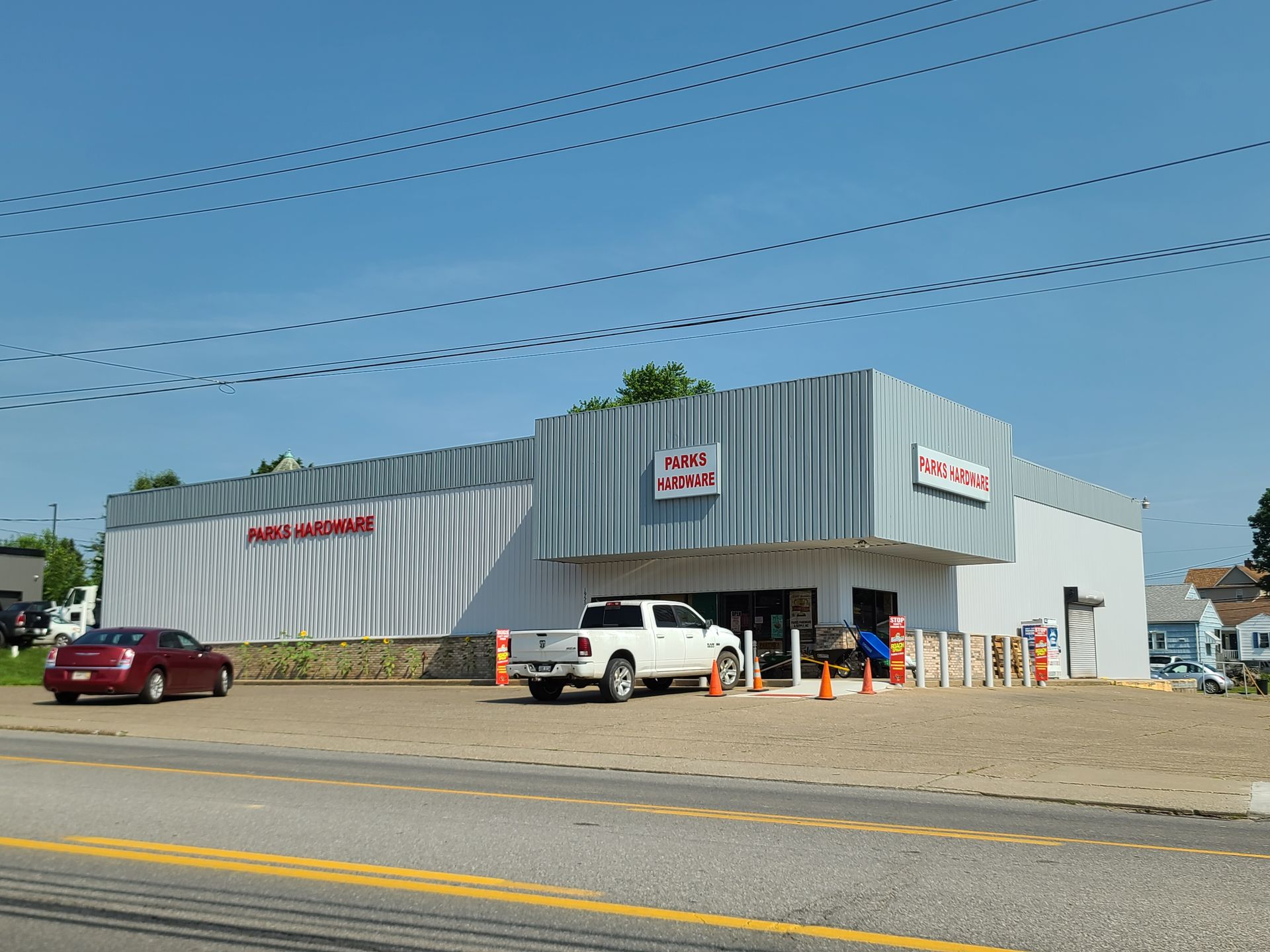 A white truck is parked in front of a building that says mail center