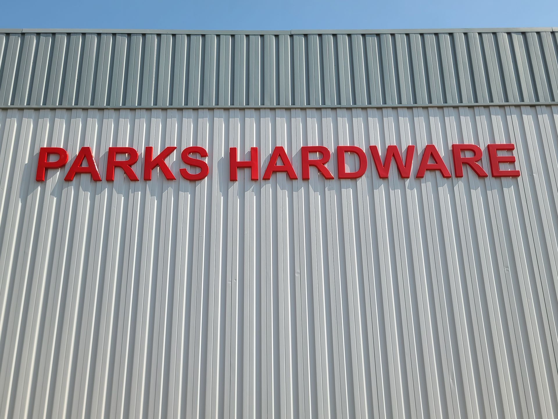 A sign on the side of a building that says parks hardware