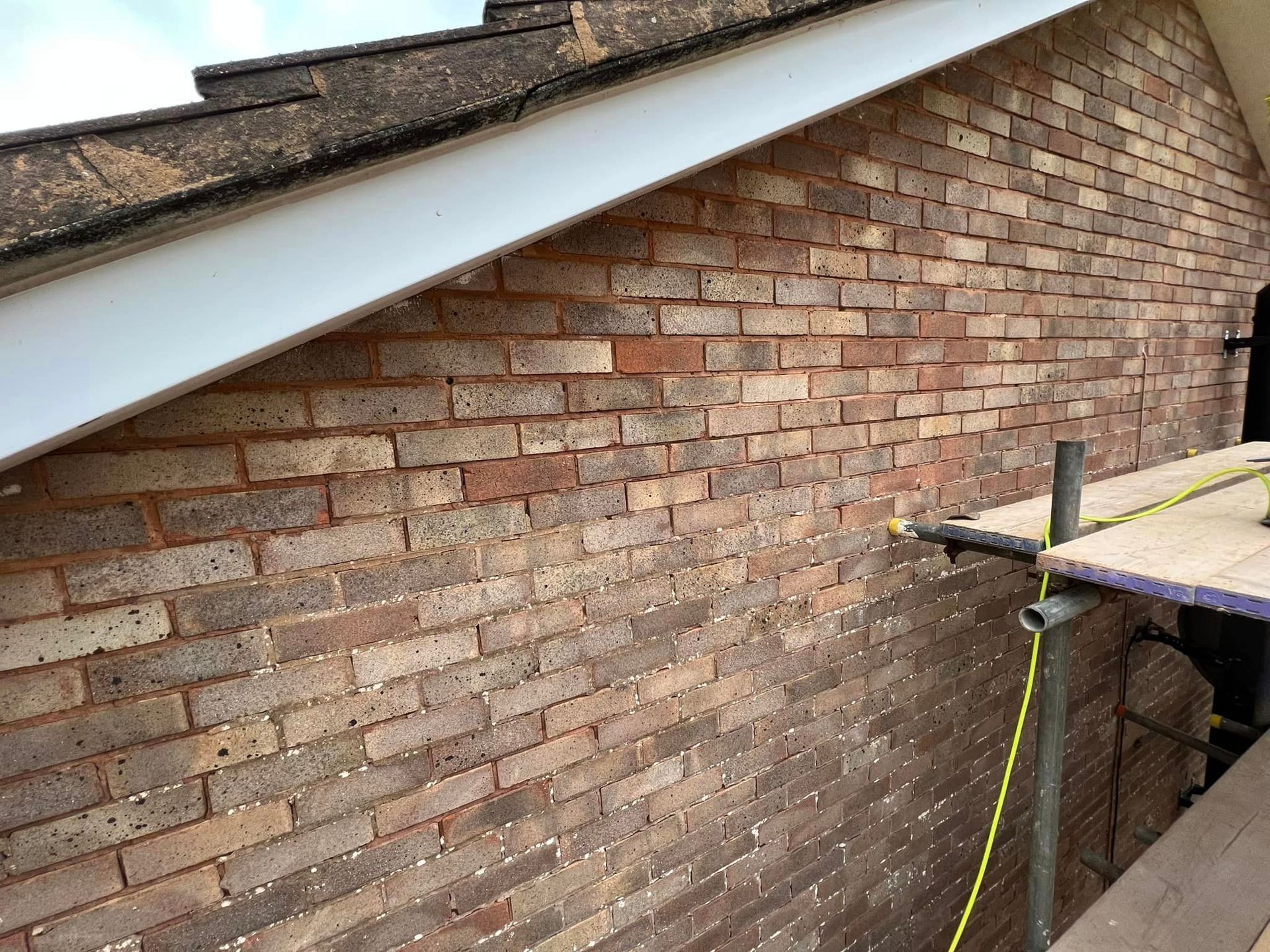 A newly repointed red brick wall.