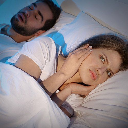 Snoring man causes sleepless woman.