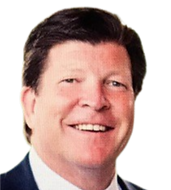 A man in a suit and tie is smiling for the camera.