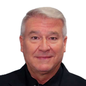 A man with gray hair and a black shirt is smiling for the camera.