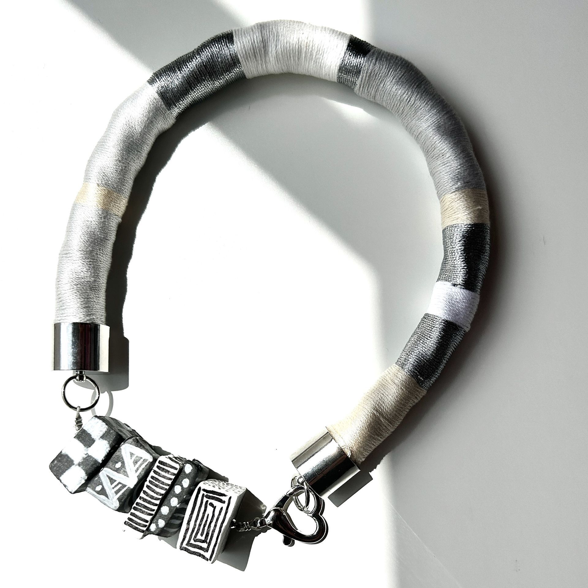 Un primer plano de un collar sobre una superficie blanca.