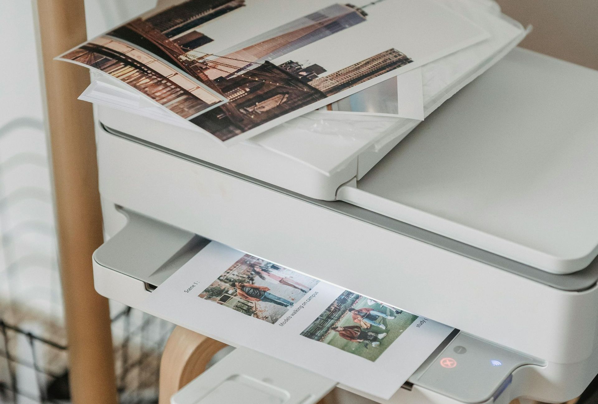 A person is holding a passport next to a brown duffel bag.
