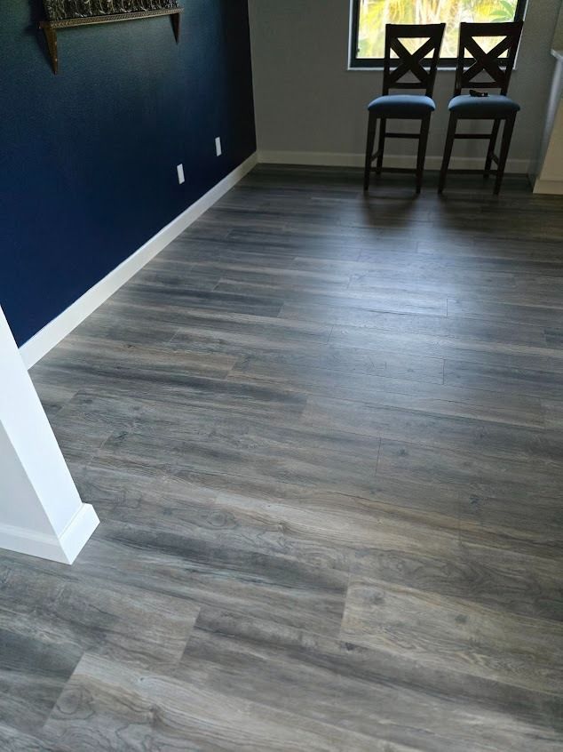 Bathroom with black and white geometric floor tile, white walls, and a gray vanity