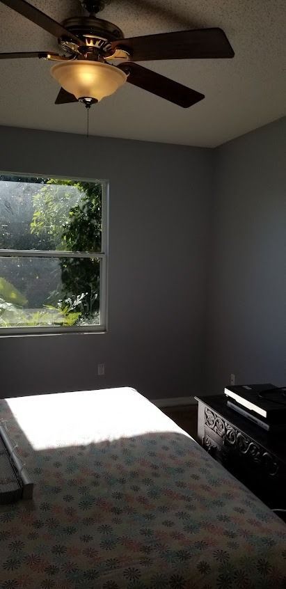 Bedroom with bed, window, dresser, and ceiling fan