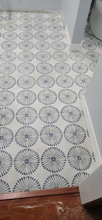 Bathroom floor with blue and white patterned tiles