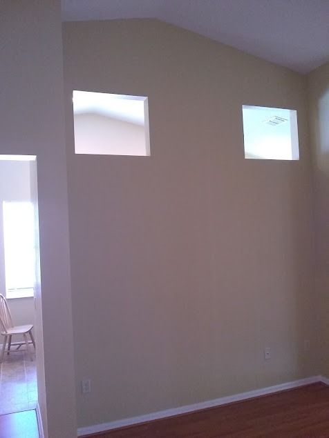 Tan walls with two square windows high up