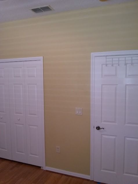 Two white doors and a closet with light yellow walls and ceiling