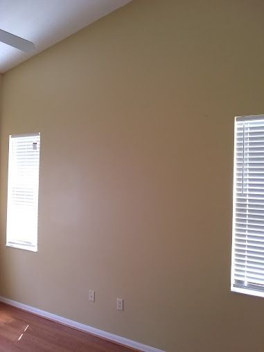 Beige wall with two windows and power outlets