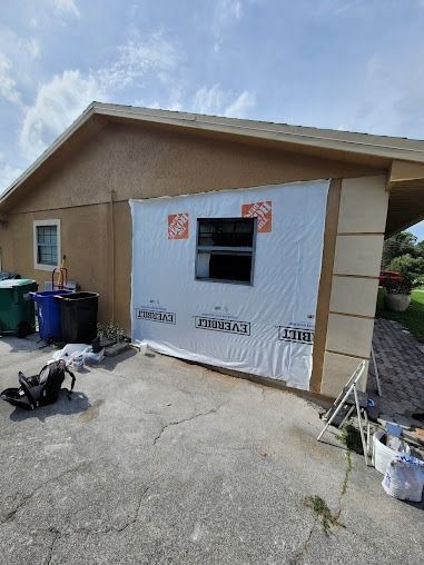 Exterior wall with a window covered in white wrap