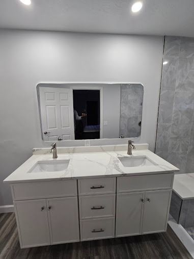 Modern white bathroom vanity with double sinks and a large mirror