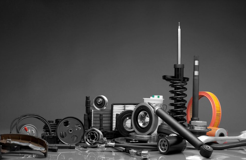 Collection of Various Black and Silver Car Parts on a Grey Background — Crypto Parts In Tuggerah, NSW