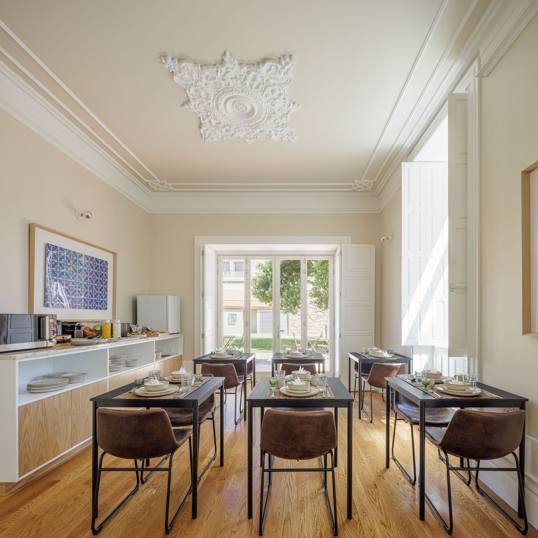 Casa Kala breakfast room with high ceilings with medallions, large windows, and natural light