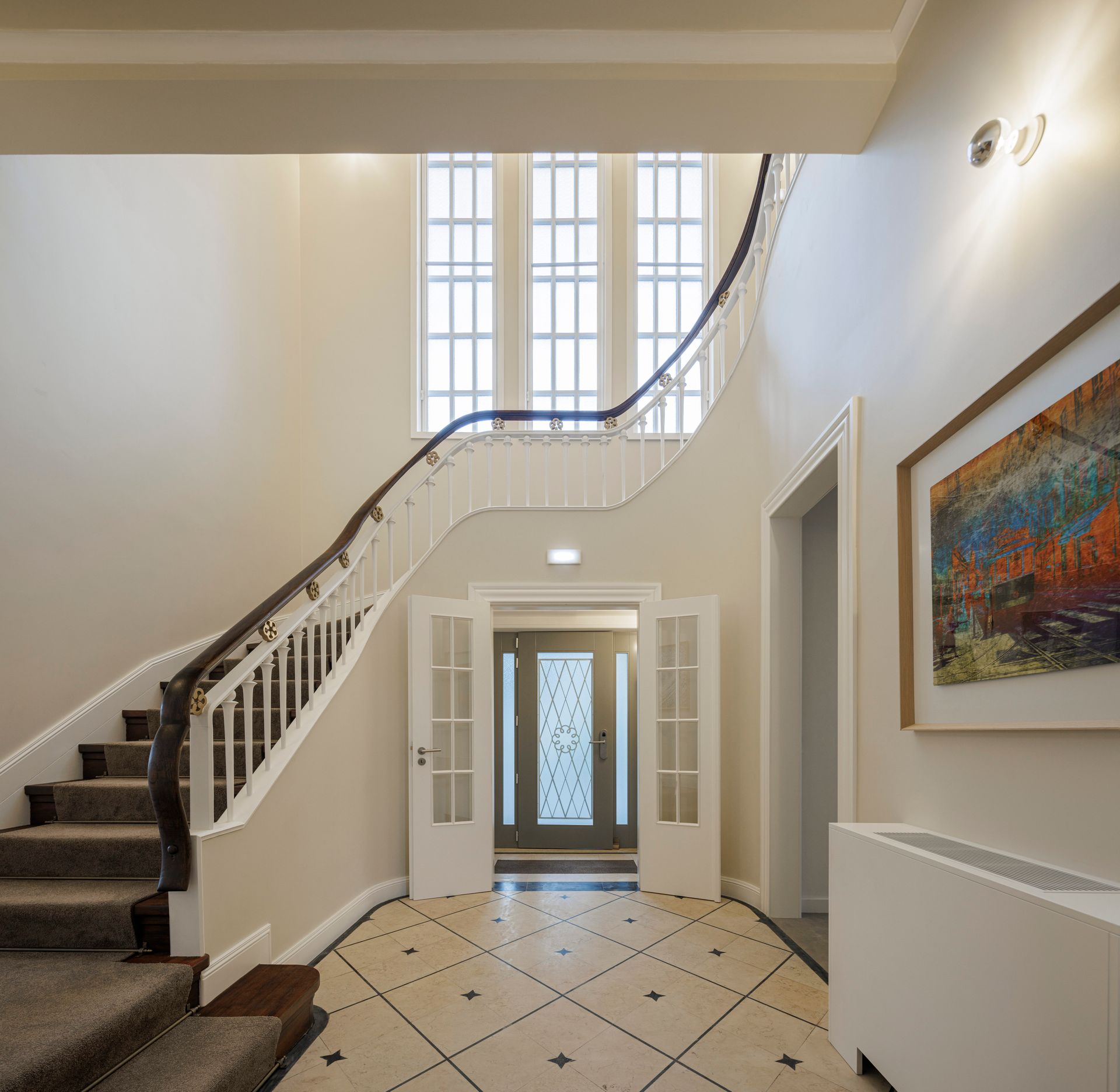 Casa Kala entrance hall with staircase and tall windows