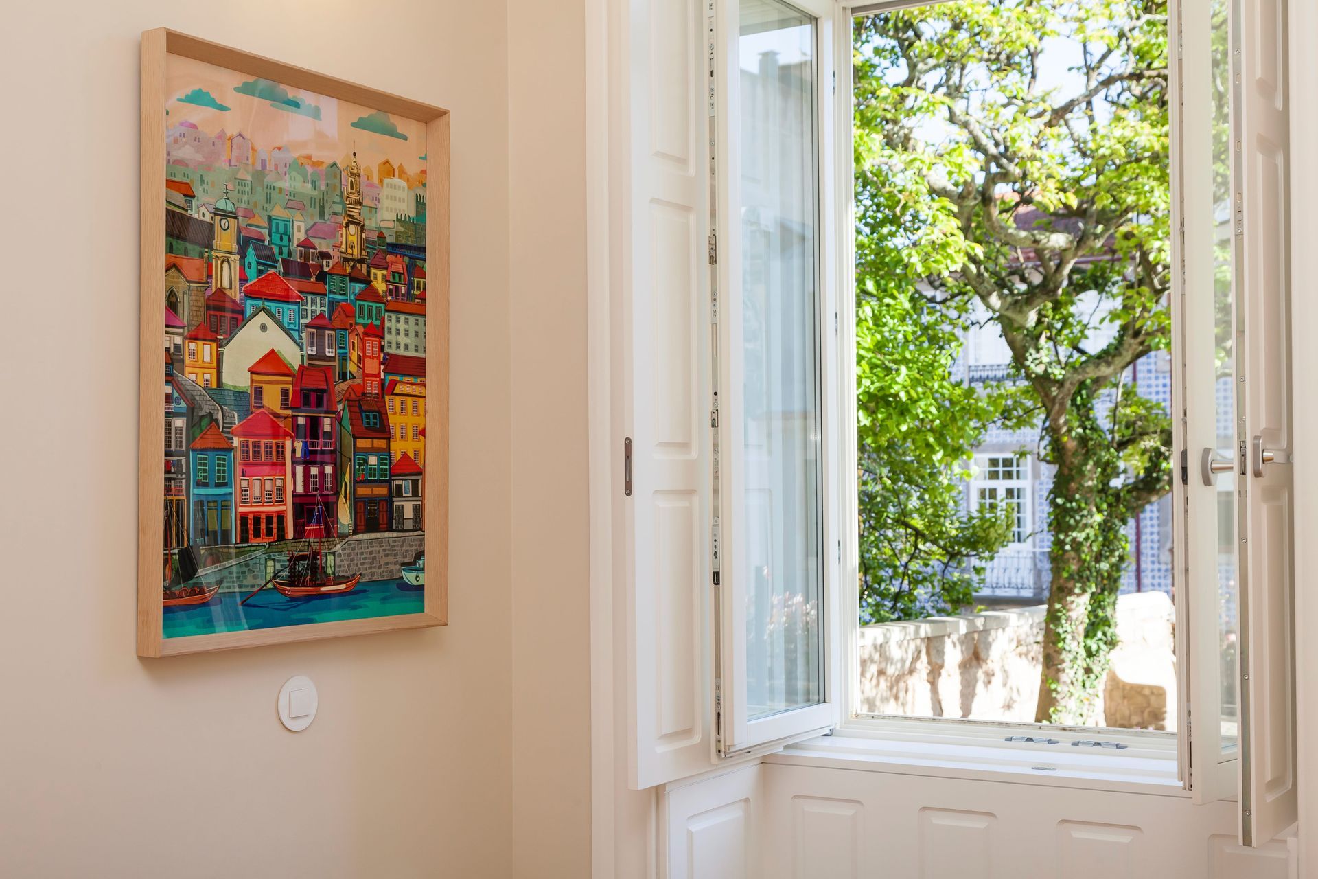 Colorful Porto artwork and open window overlooking Casa Kala garden