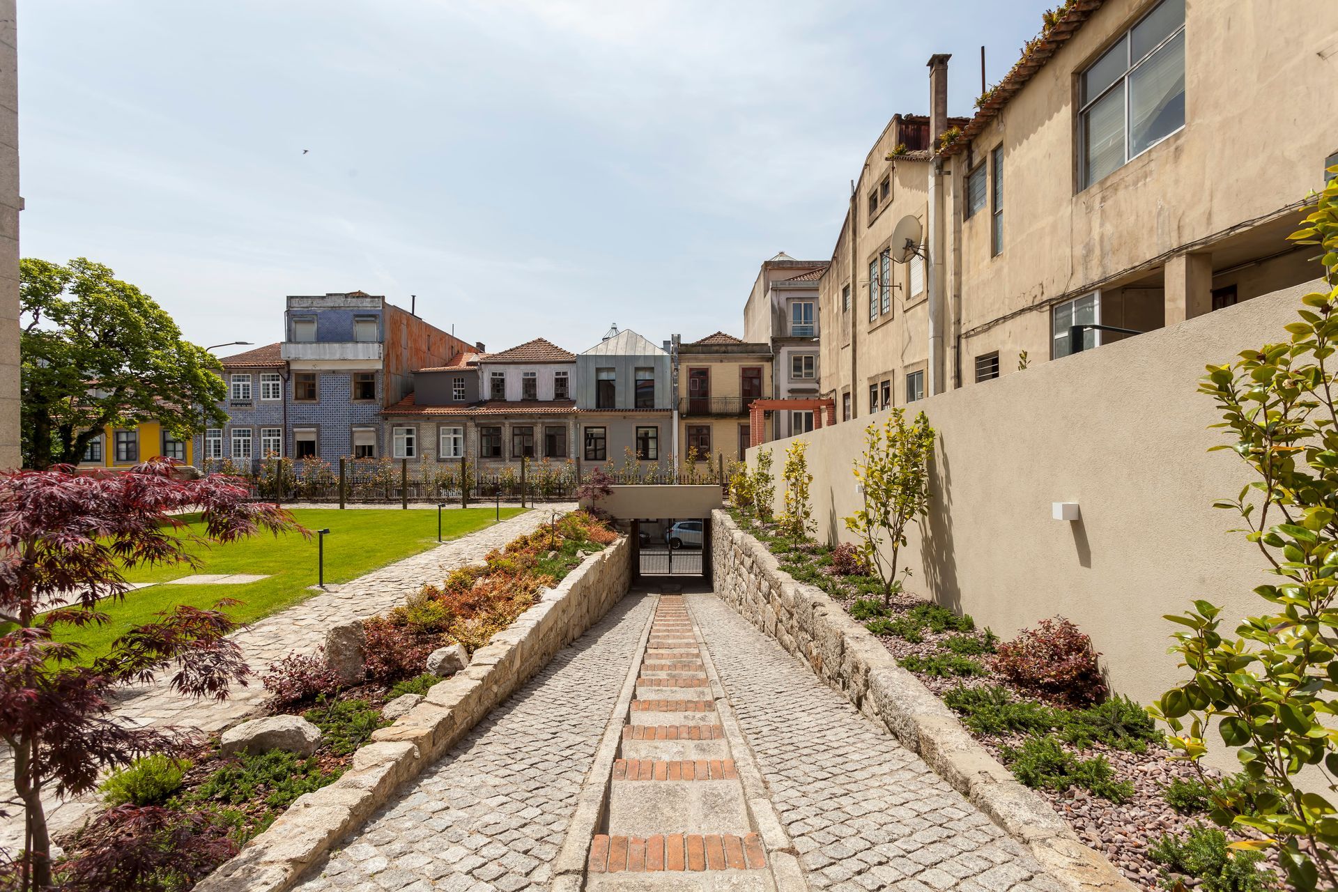 Stone path entrance with townhouses in the background