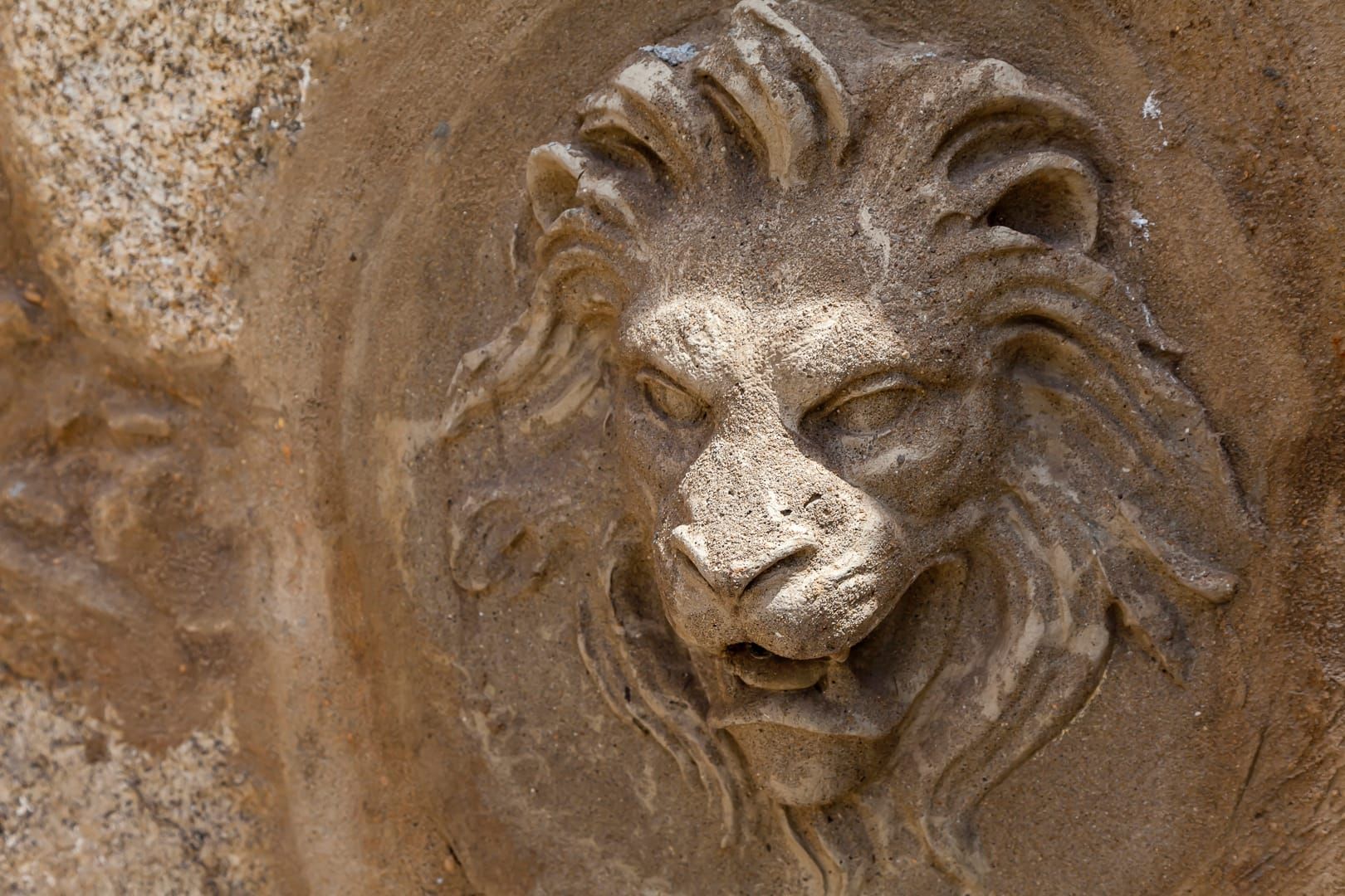 Stone lion-head fountain detail in Casa Kala’s garden
