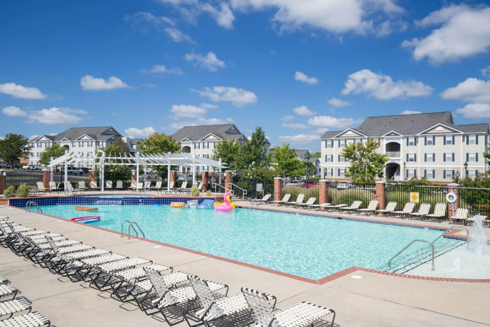 A large swimming pool surrounded by chairs at Belmont Landing.