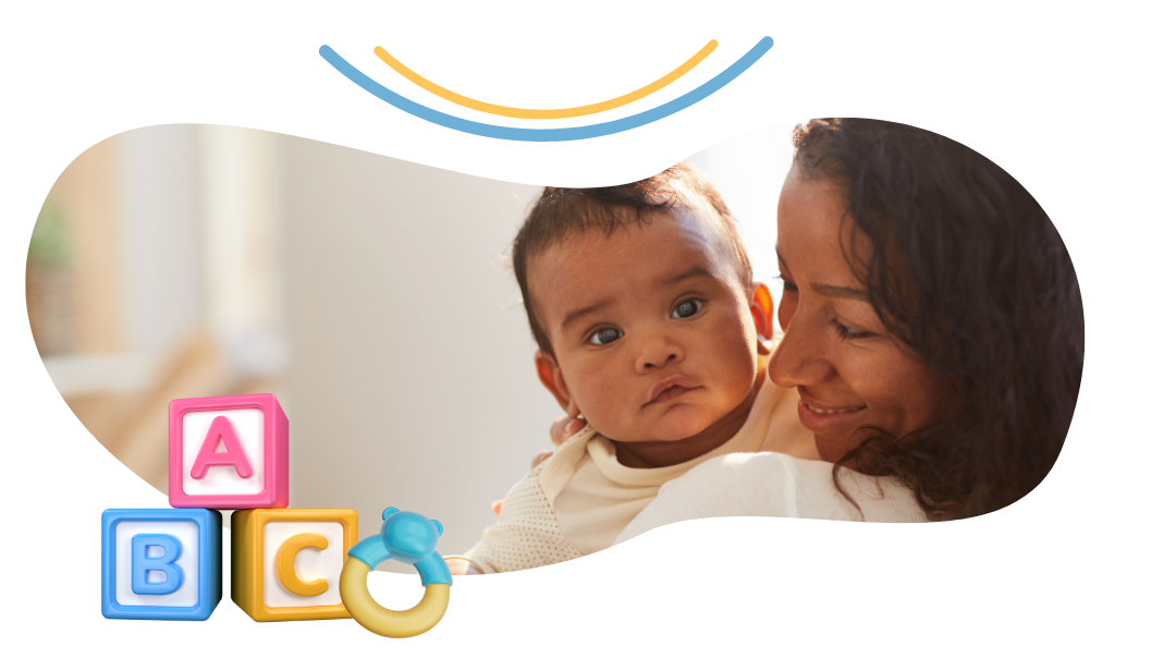 A woman is holding a baby in her arms.