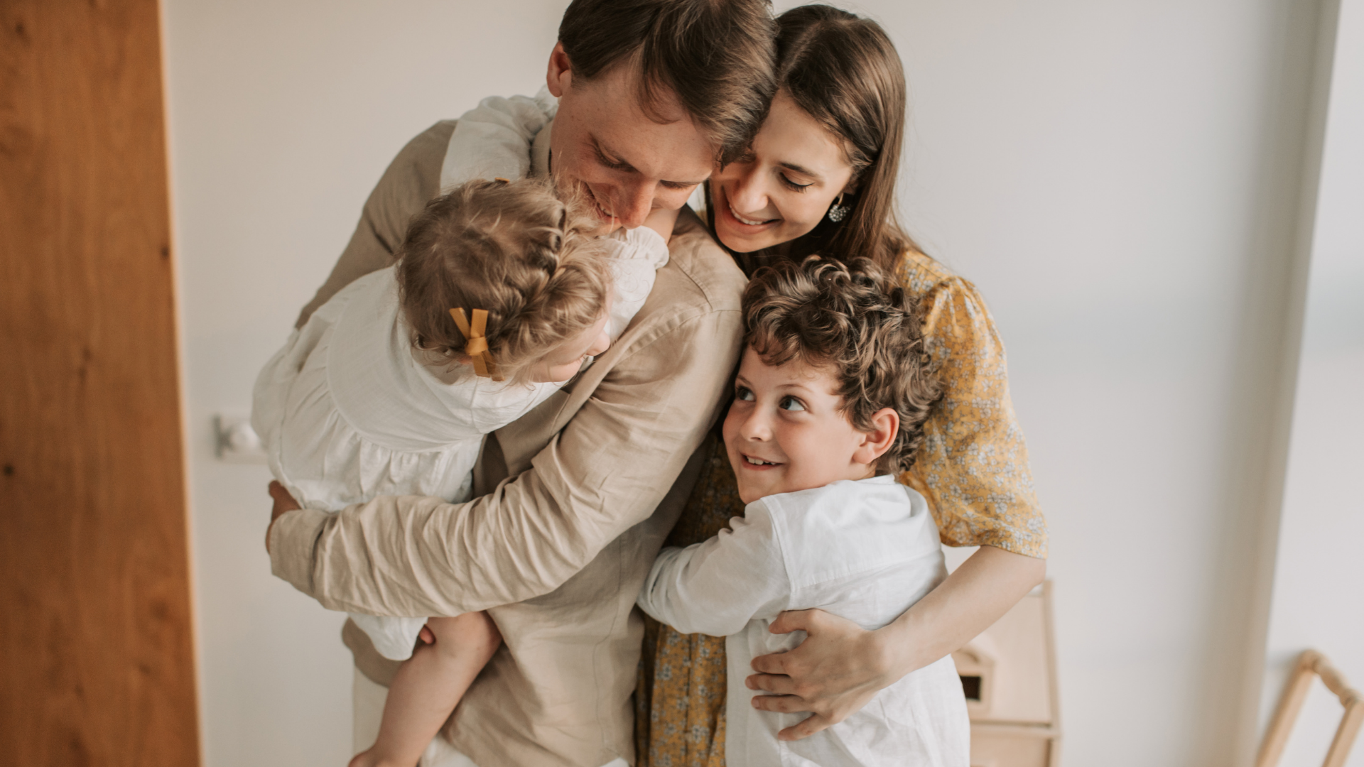 A person using a forearm crutch shakes hands with an individual in a professional suit in an office setting.