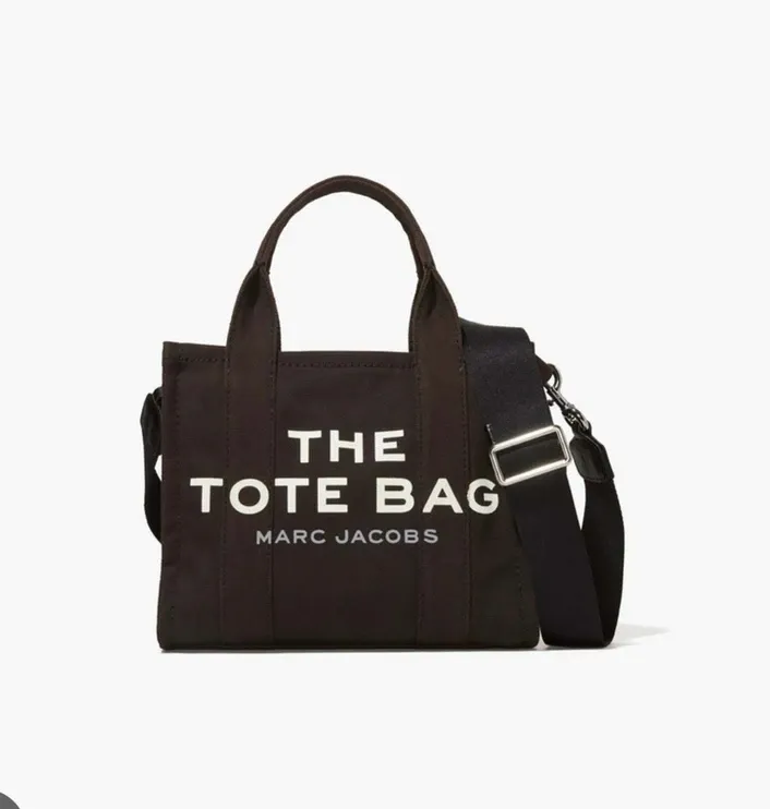 A black tote bag by marc jacobs with a black strap