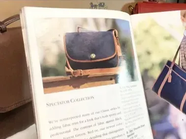 A book is open to a page with a picture of a purse on it