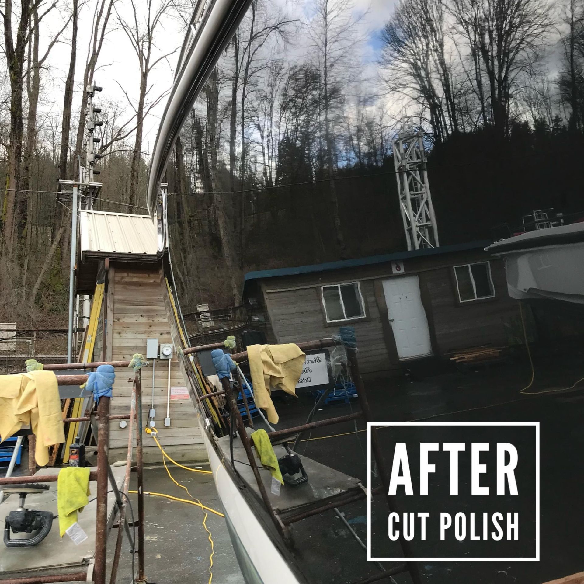 Black boat hull reflects the surrounding environment. Polished after cutting.