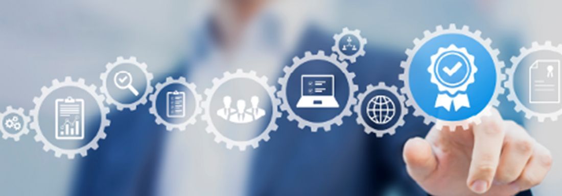 A female and male florist at a store counter looking at a computer.