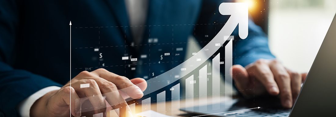 A female and male florist at a store counter looking at a computer.