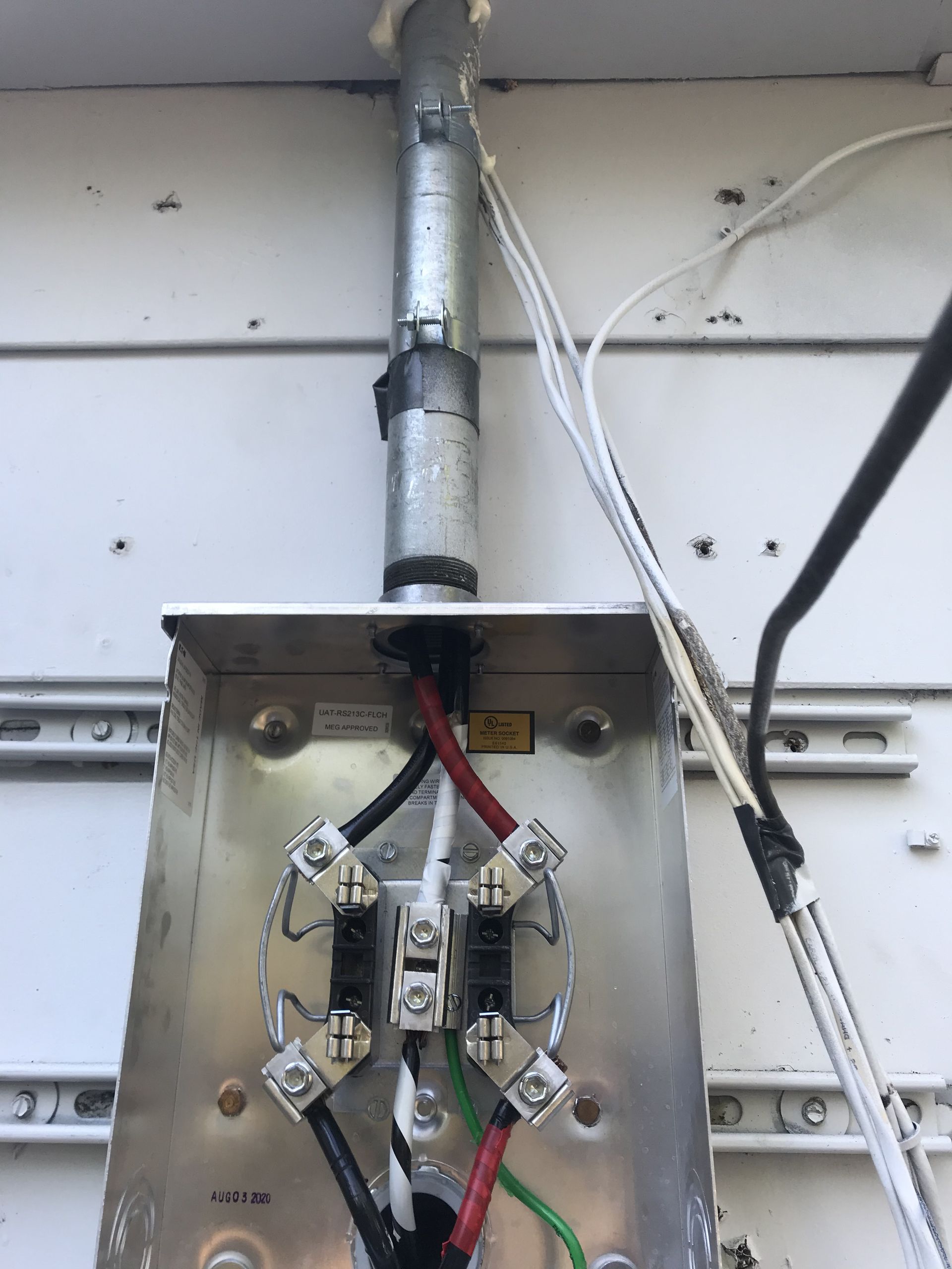 Electrical installation with service mast wiring setup for safe and reliable home power connection.