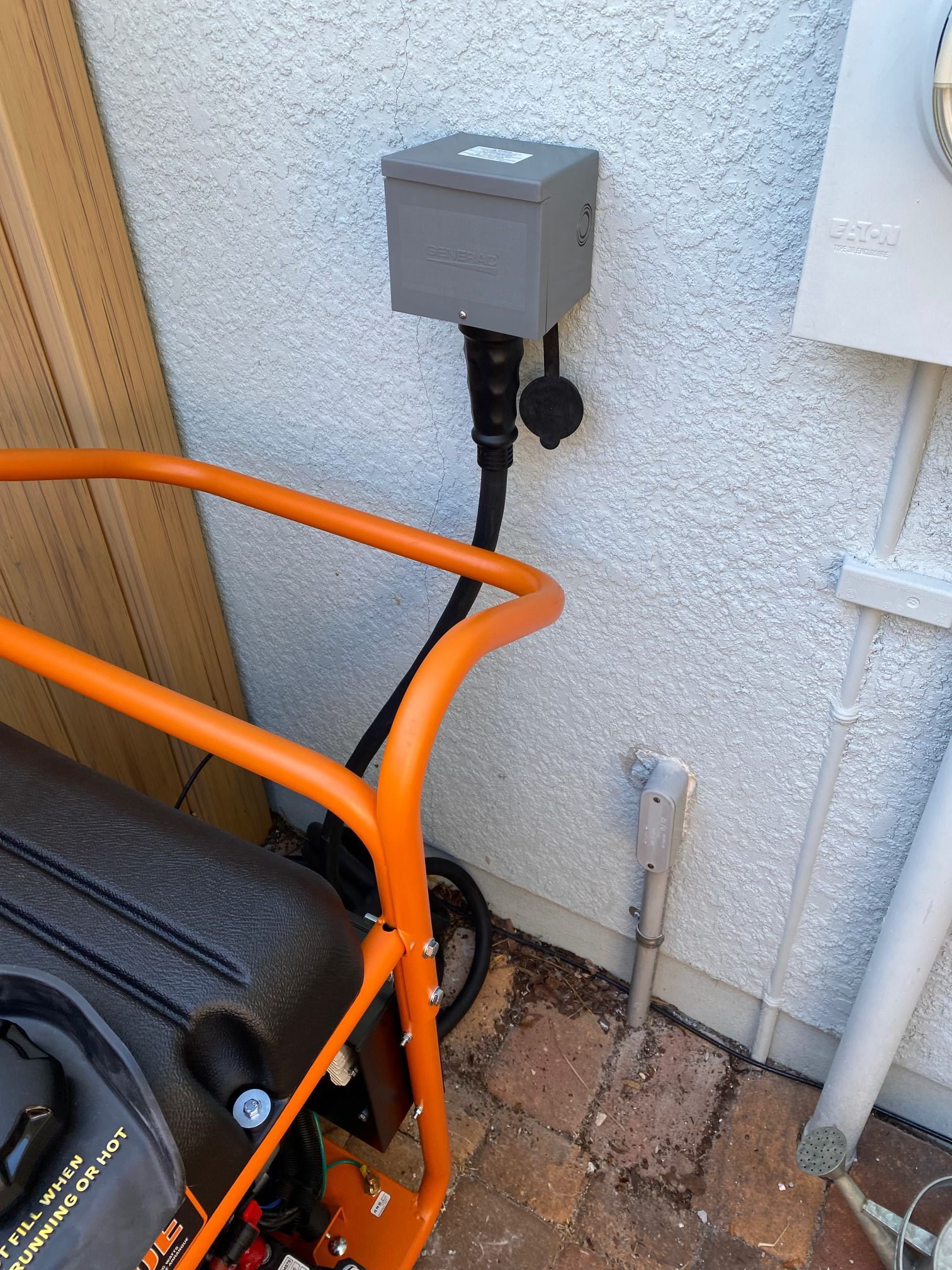 Generator electrician installing a transfer switch for backup power and emergency electrical services.