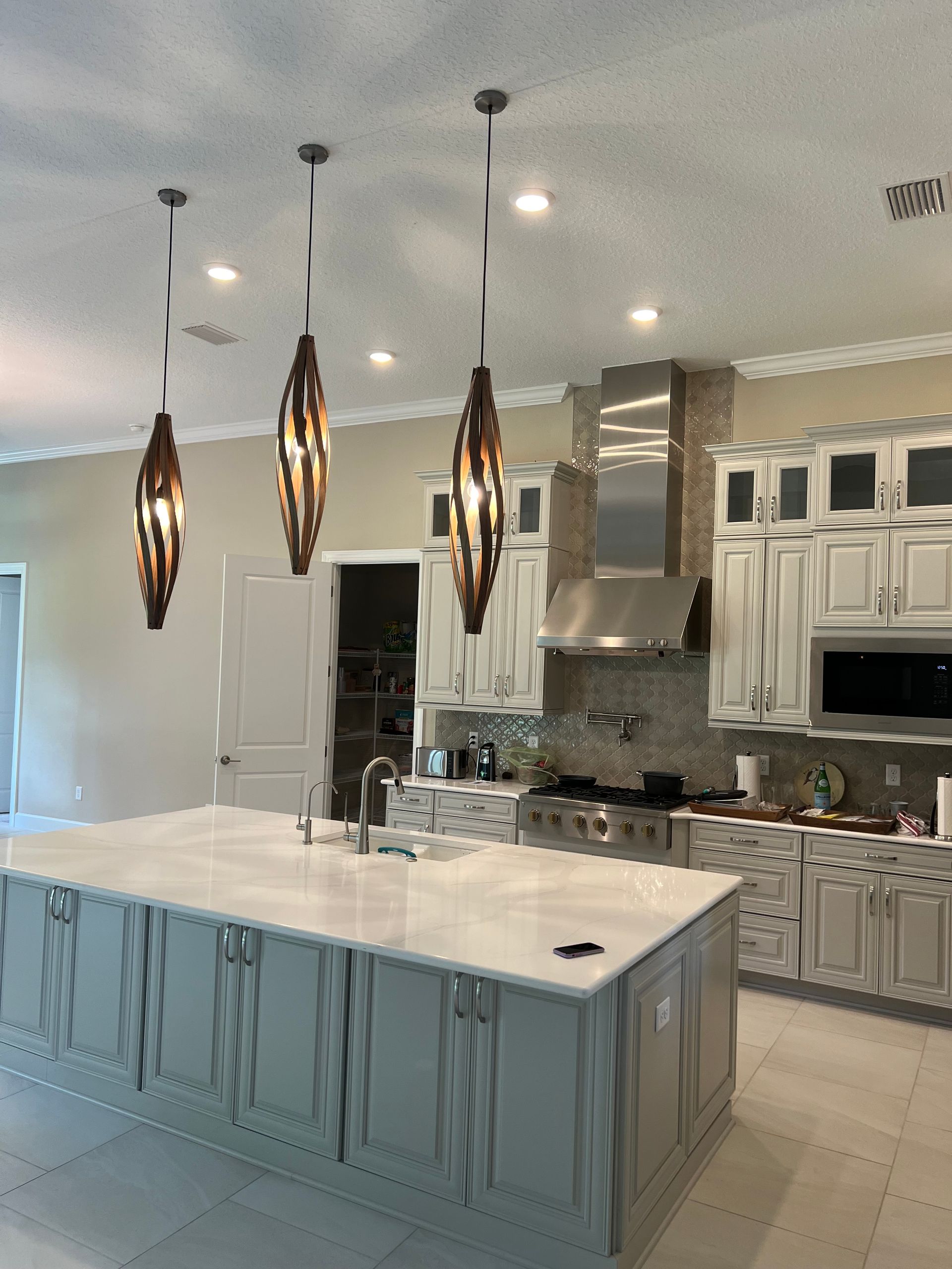 Modern pendant light installation over a kitchen island for stylish and energy-efficient home lighting solutions.