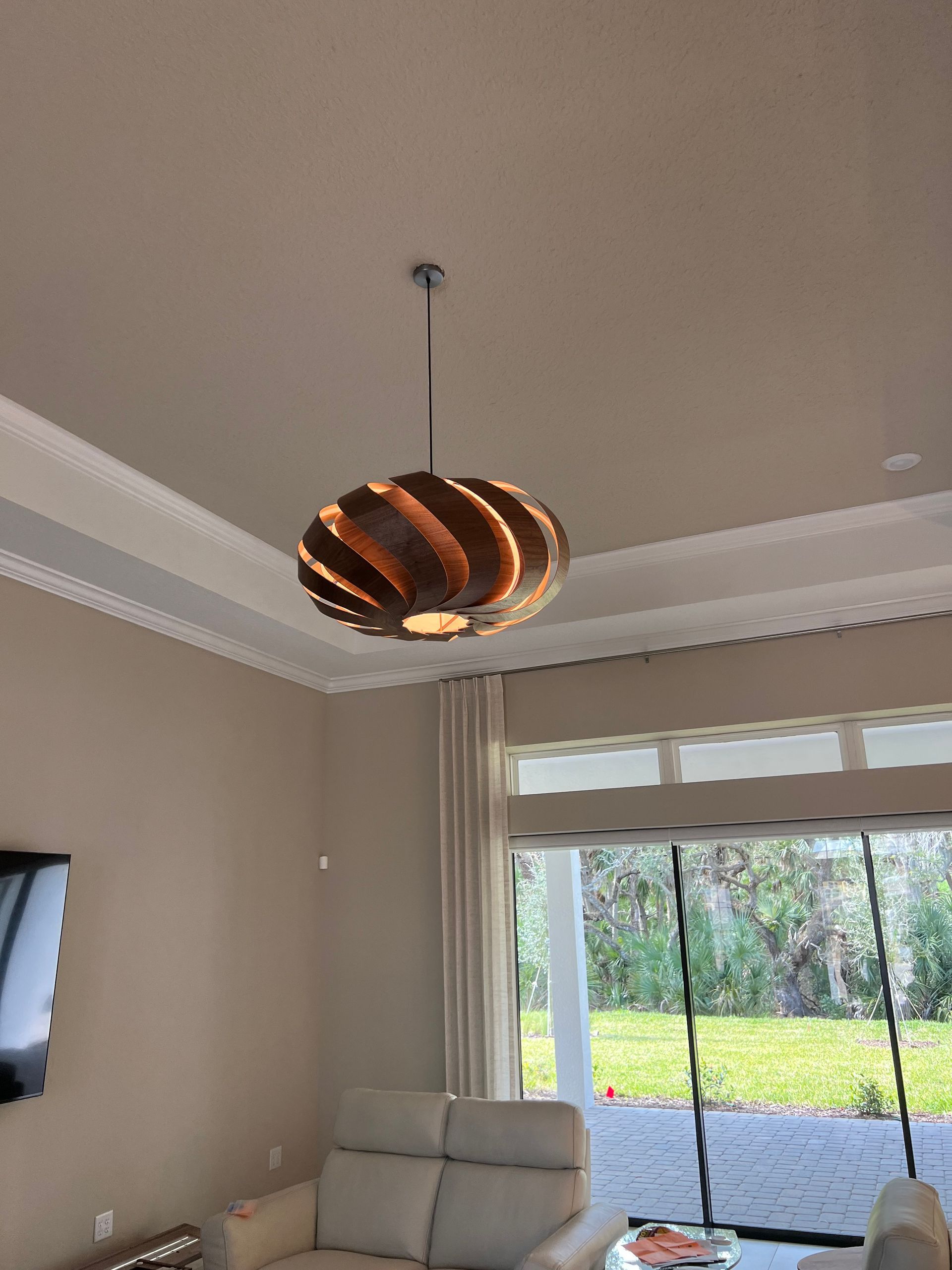 Modern pendant light installation in a living room for stylish and energy-efficient home lighting solutions.
