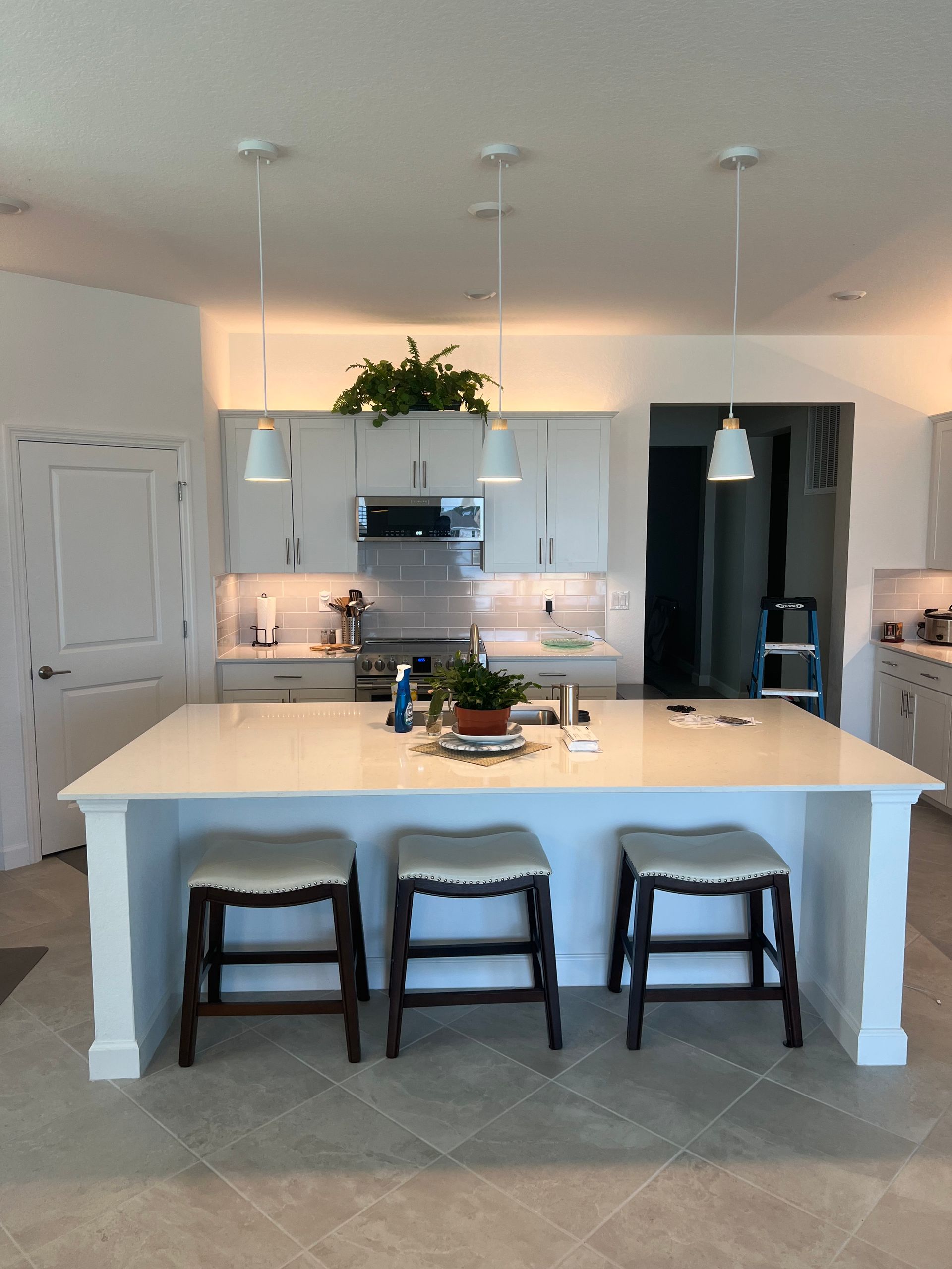 Kitchen pendant light installation with modern fixtures for improved lighting and energy-efficient electrical solutions.