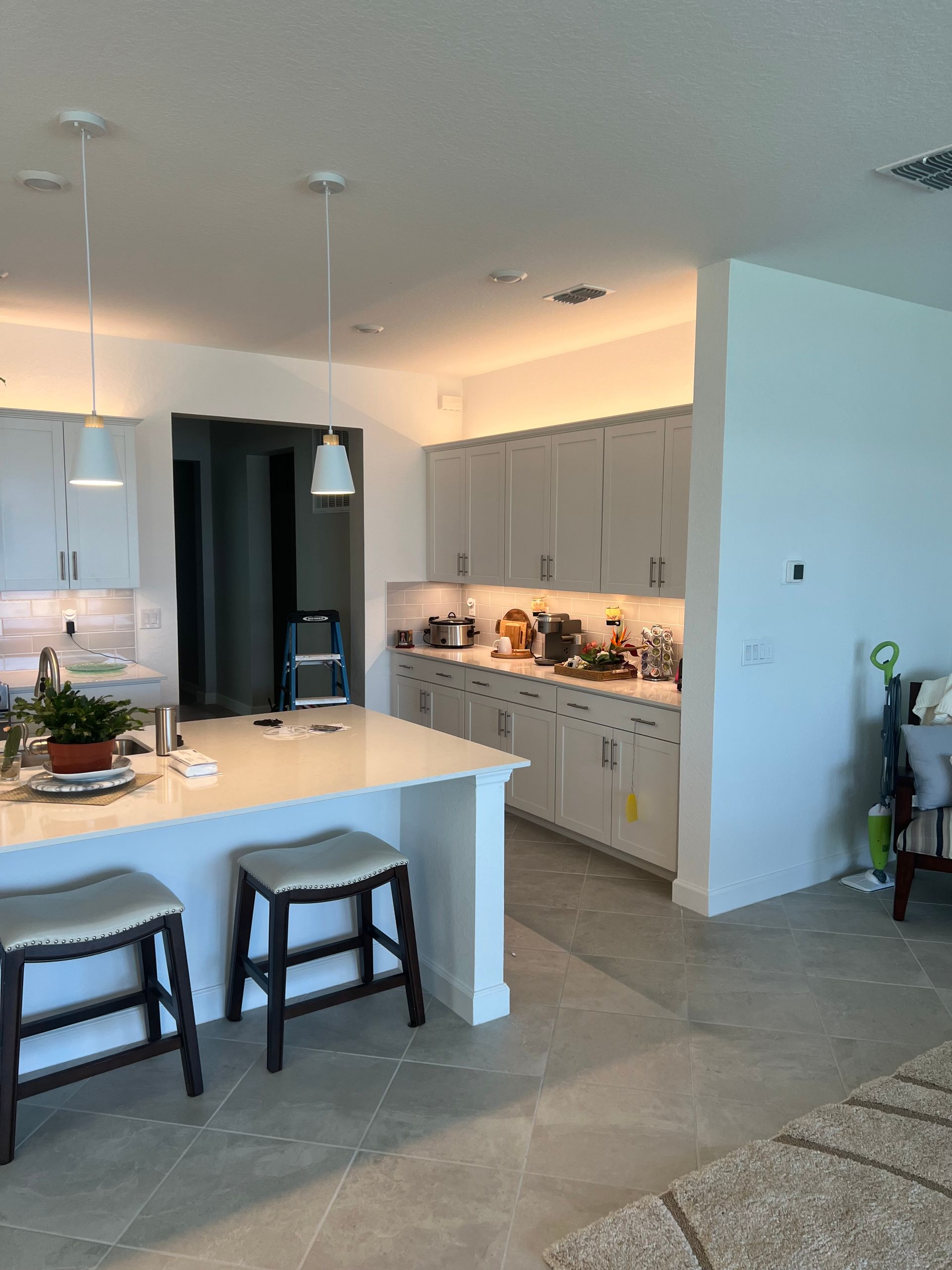 Professional electrical installation of stylish pendant lights in a modern kitchen for enhanced lighting and efficiency.