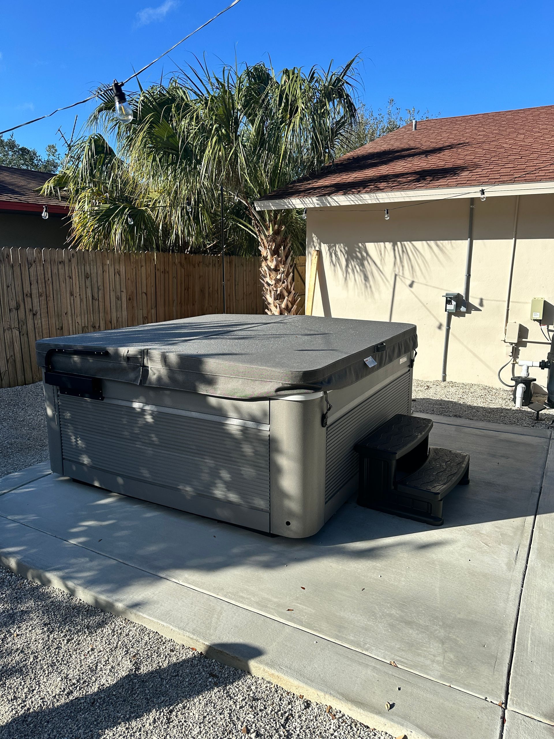 Hot tub electrical installation with secure outdoor wiring and electrical panel setup for safe home power solutions.