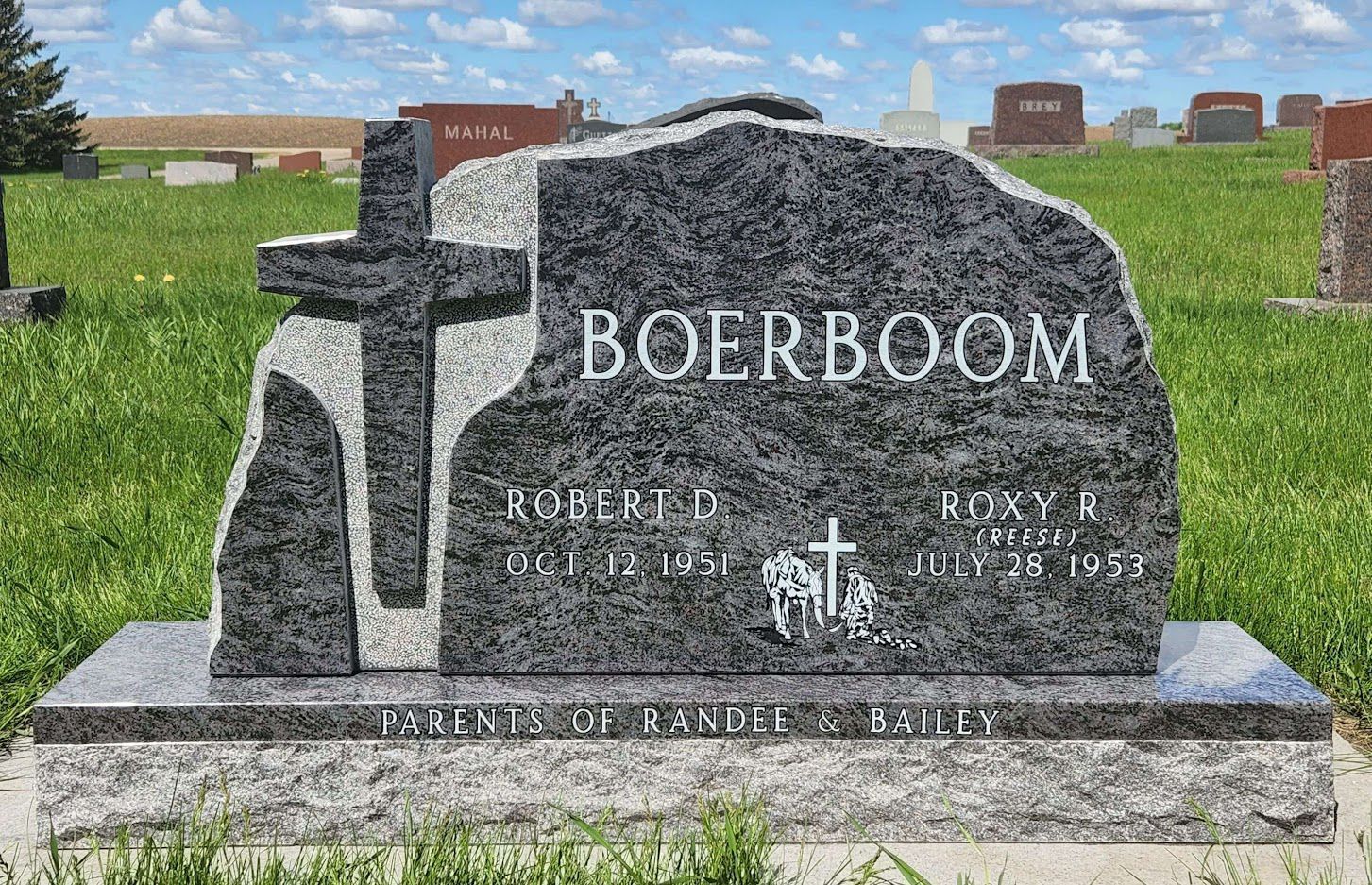 Gravestone for the Williams family with engraved landscape and names: Morgan E. and Juanita M.