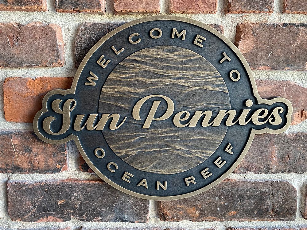 Black granite memorial with golden cross and inscription: