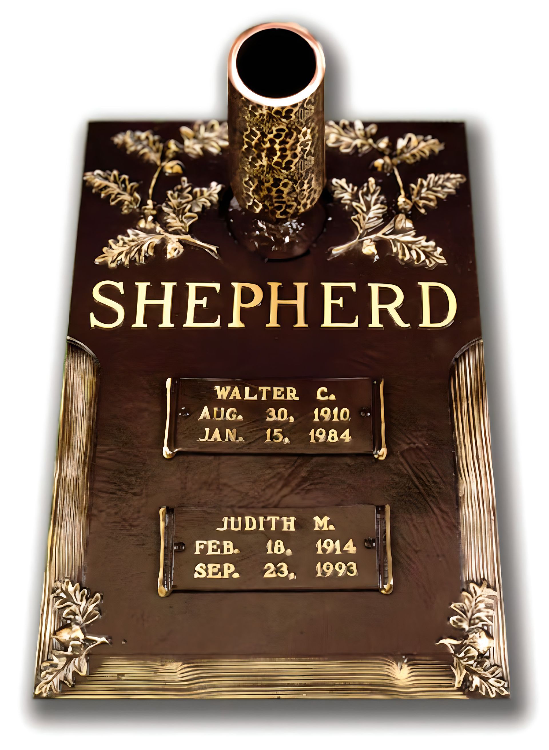 Headstone of Heather D. Schneider. Bronze plaque with birth and death dates, angel, and floral border.