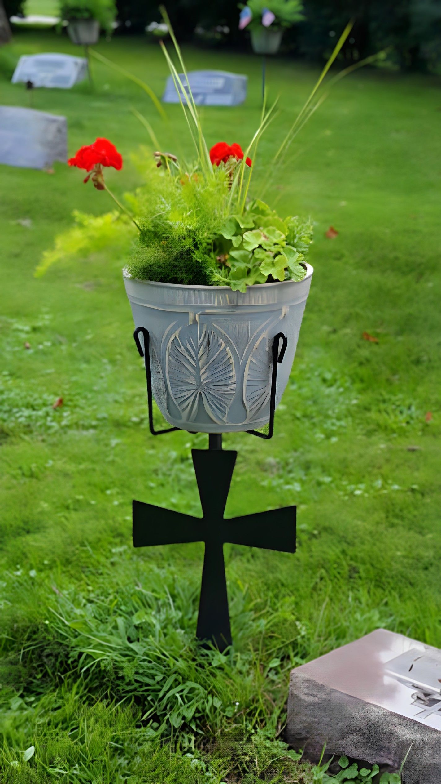 Flower vase at a grave with inscription