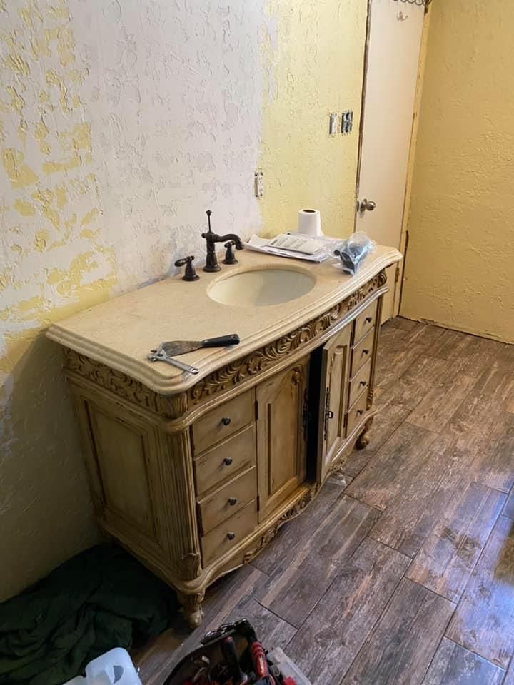 A bathroom with a sink and a mirror in it.