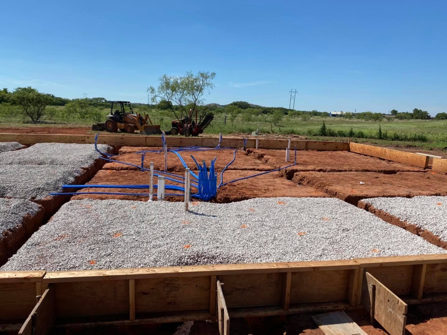 A construction site with a tractor in the background