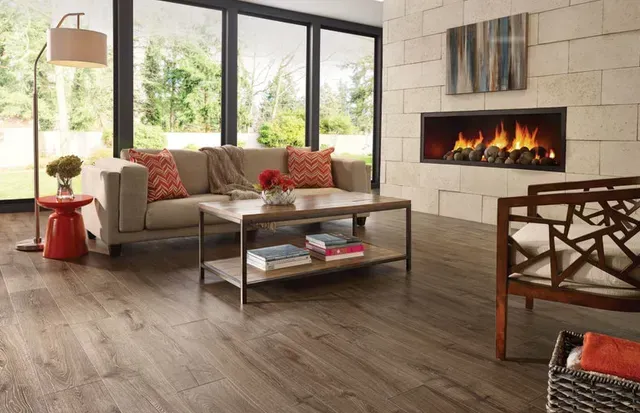 A living room with hardwood floors and a fireplace.