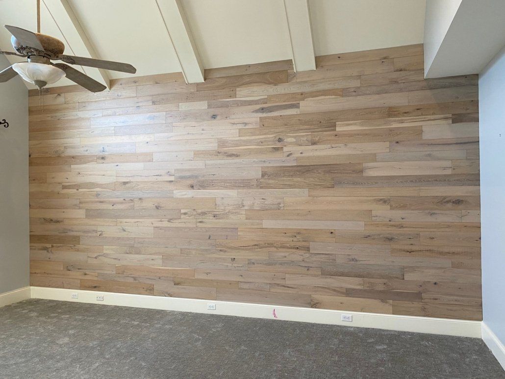 A room with a wooden floor and a ceiling fan