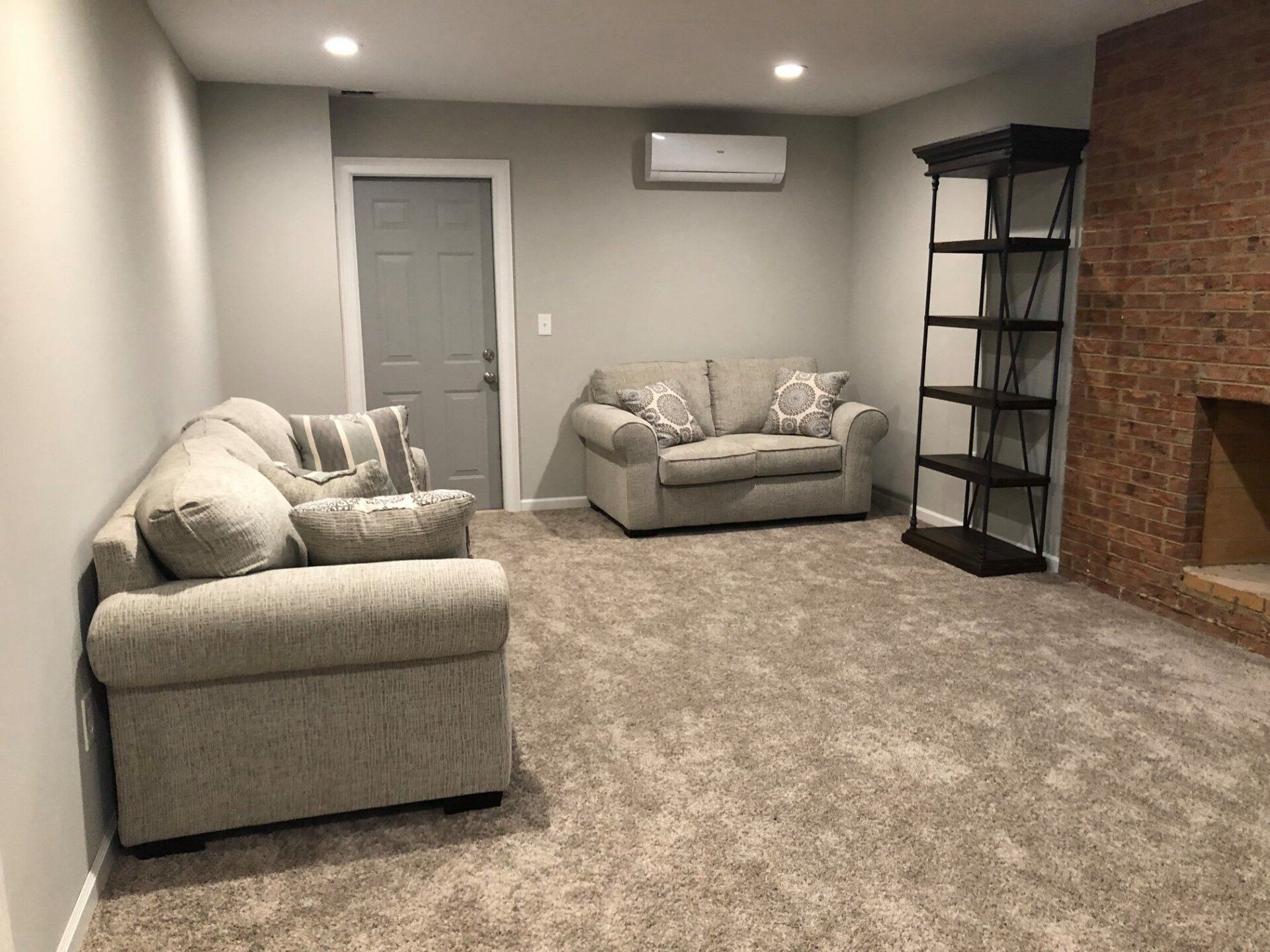 A living room with two couches and a fireplace.