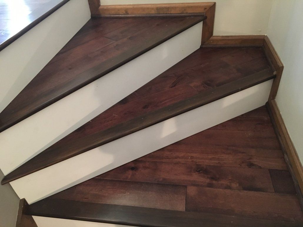 A set of wooden stairs with white risers